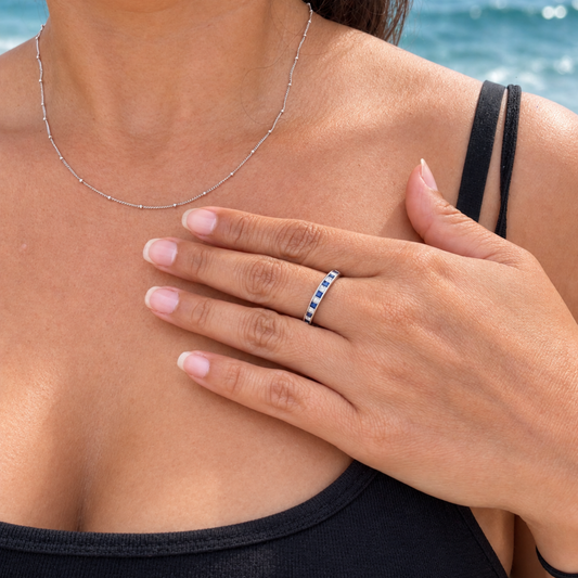 Emory sapphire and princess cut diamond ring worn on hand