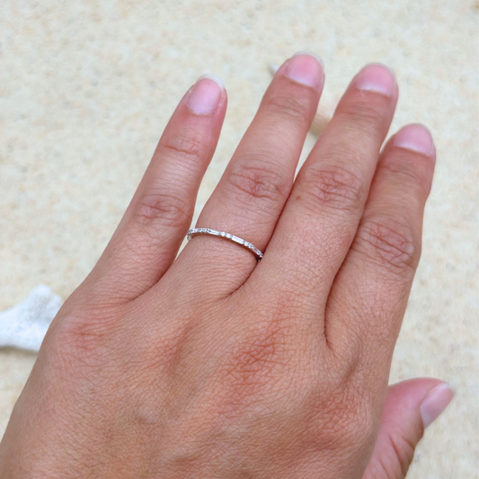 18kt white gold diamond band with baguette and round diamonds worn on hand