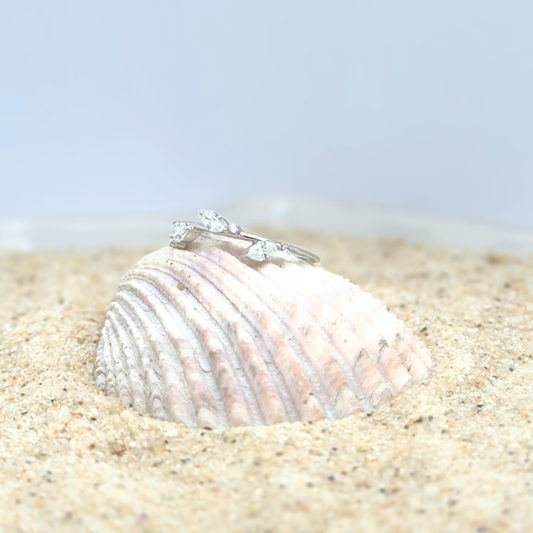 Marquise and round diamond white gold band worn on hand, nature-inspired design