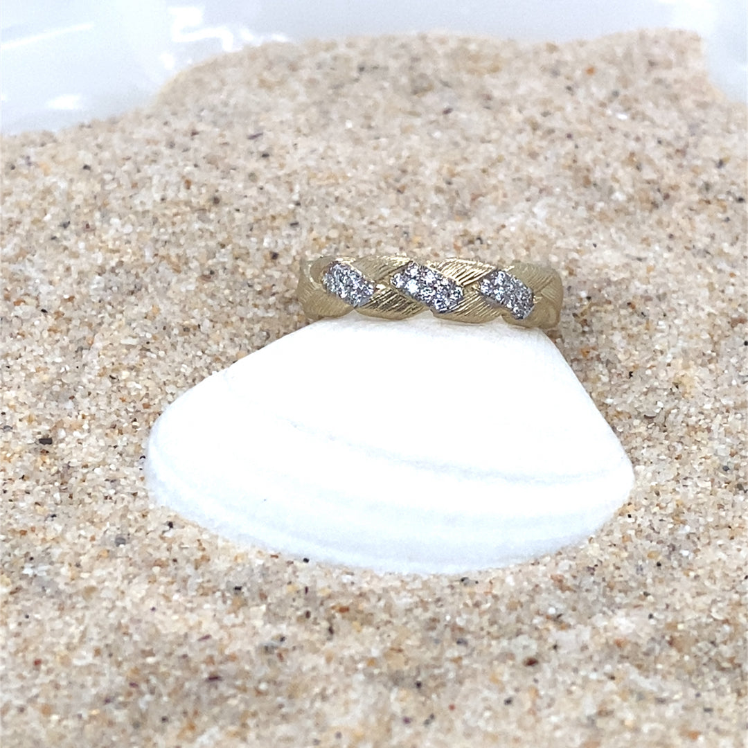 Textured gold ring with round brilliant diamond accents on shell