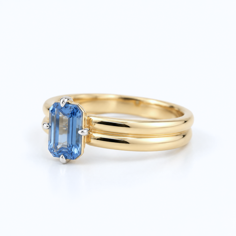 Emerald-cut Ceylon sapphire ring with compass-set claws side view