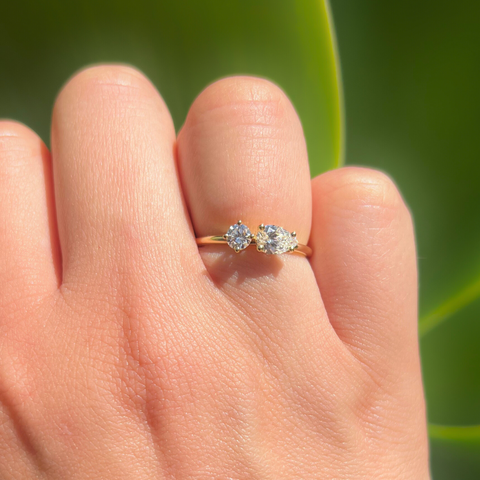 18kt yellow gold Toi et Moi custom diamond ring styled on hand.