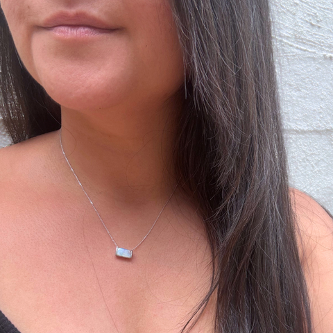 Bespoke opal necklace worn, showcasing natural colour play