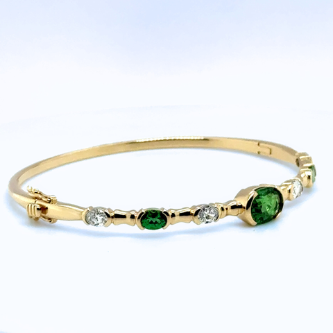 Tsavorite and diamond bangle in 14k yellow gold