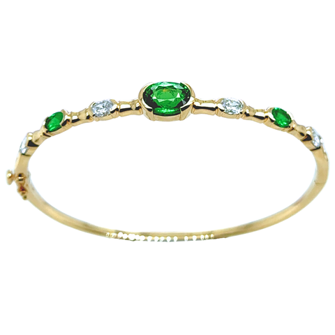 Tsavorite and diamond bangle in 14k yellow gold