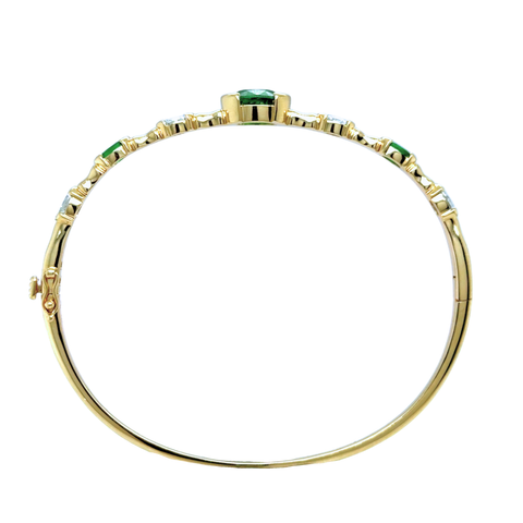 Tsavorite and diamond bangle in 14k yellow gold