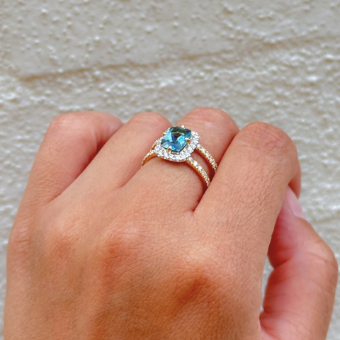 Santa Maria aquamarine ring worn on hand, showcasing vivid blue cushion-cut gemstone and diamond halo