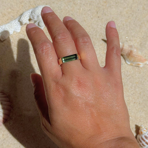 Green tourmaline gemstone ring worn on hand