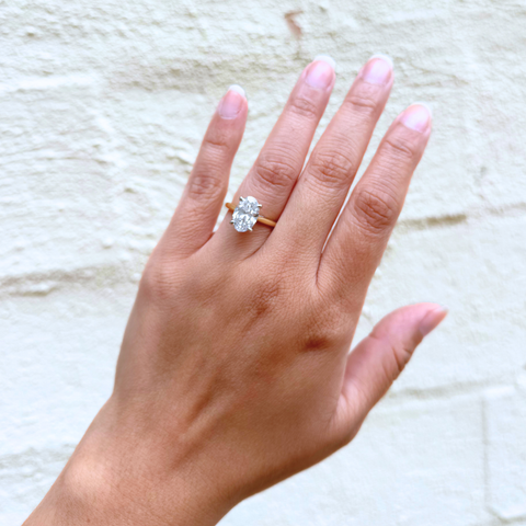 Himalayan Blue Poppy oval diamond engagement ring on hand