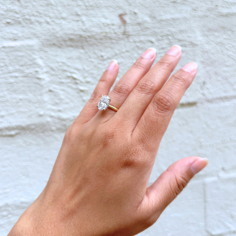 Himalayan Blue Poppy oval diamond engagement ring on hand