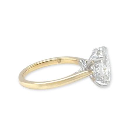 Side profile of oval solitaire diamond ring with hidden halo