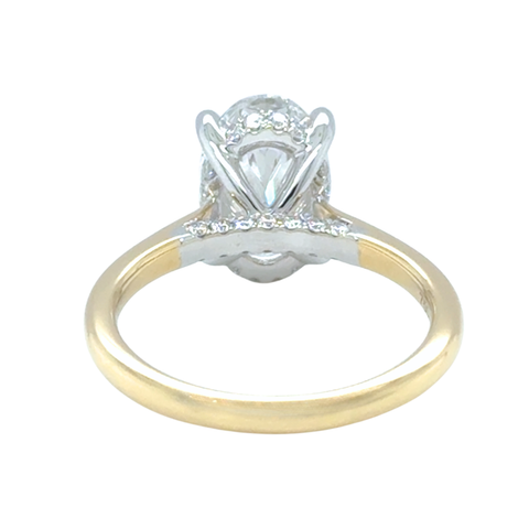 Oval diamond ring with platinum setting and yellow gold band 