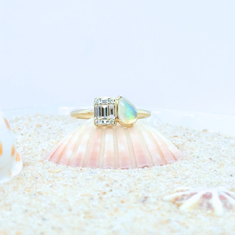 hand wearing custom opal diamond ring