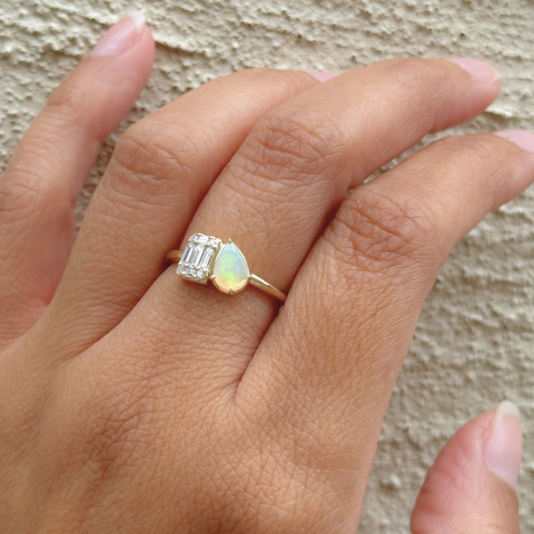 hand wearing custom opal diamond ring
