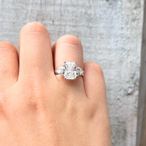 Andromeda radiant-cut lab diamond trilogy ring worn on hand, elegant modern engagement ring