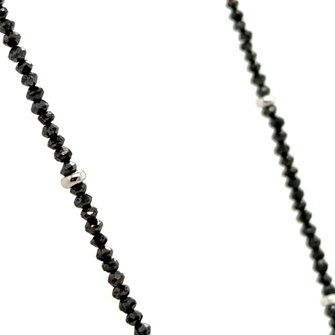 Black diamond faceted bead strand necklace displayed on neutral background
