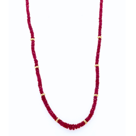 Natural Burmese ruby beaded strand necklace laid flat with 14kt gold rondels and clasp.