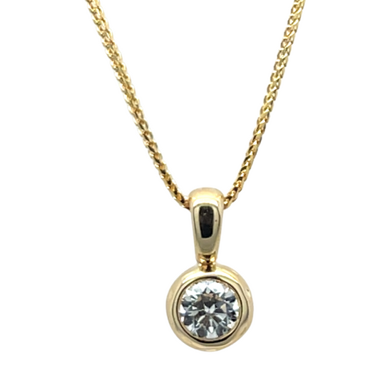 Gold necklace with a diamond pendant on a white background