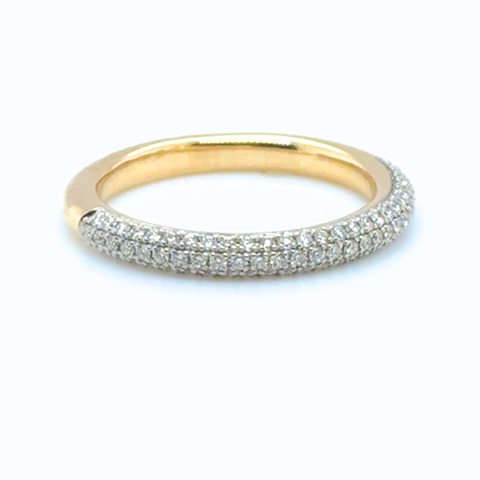 Gold ring with diamond accents on a white background