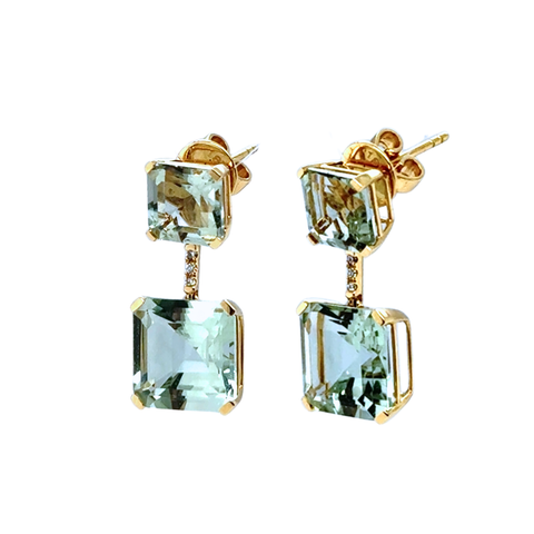 Gold earrings with green gemstones on a white background