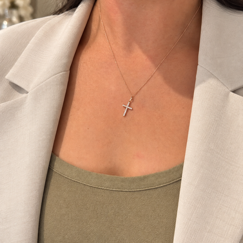 Faith diamond cross pendant in yellow gold worn