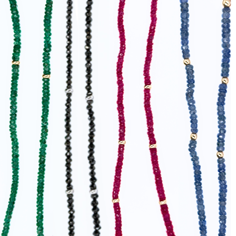 Gemstone strand comparison showcasing Burmese ruby, Mozambique ruby, black diamond, sapphire and emerald strands.