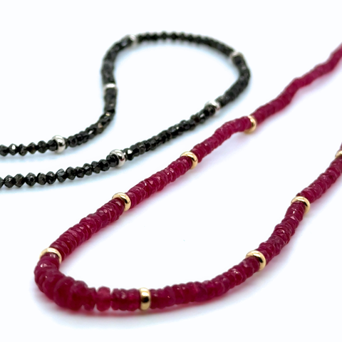Gemstone strand comparison showcasing Burmese ruby and black diamond strand