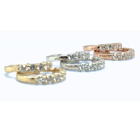 Collection of mixed-gold diamond huggie earrings showcased with round lab grown diamonds.