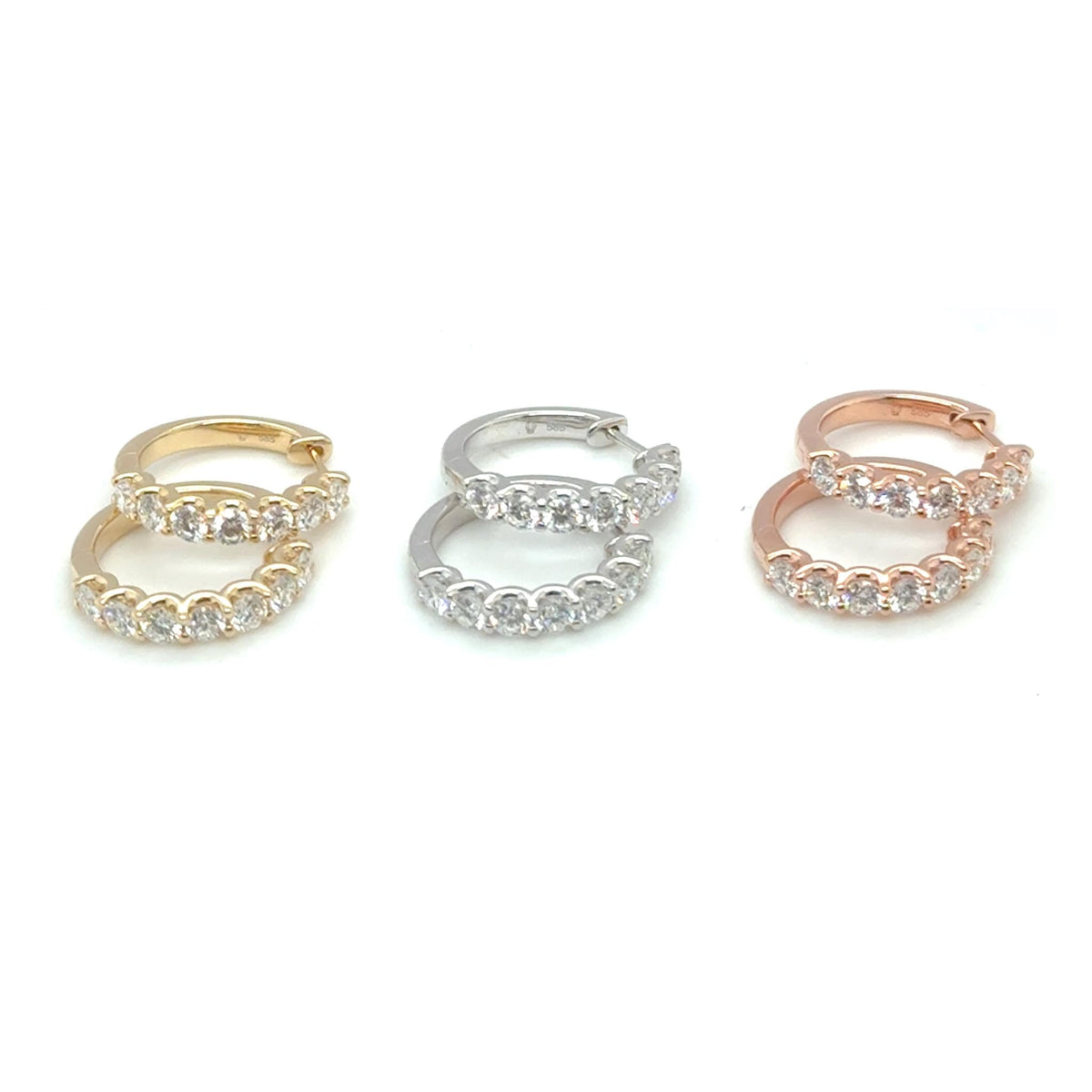 Stacked diamond huggie earrings in 14kt gold featuring round brilliant lab grown diamonds.