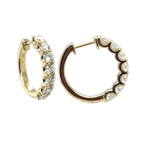 Diamond huggie earrings in yellow and white gold with round brilliant lab grown diamonds.