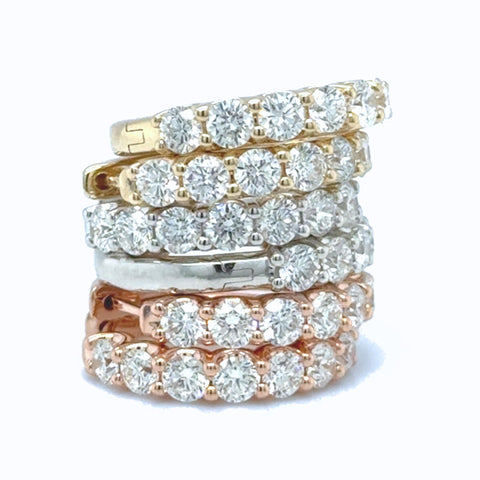 Assorted diamond huggie earrings in yellow, white and rose gold with round lab grown diamonds.