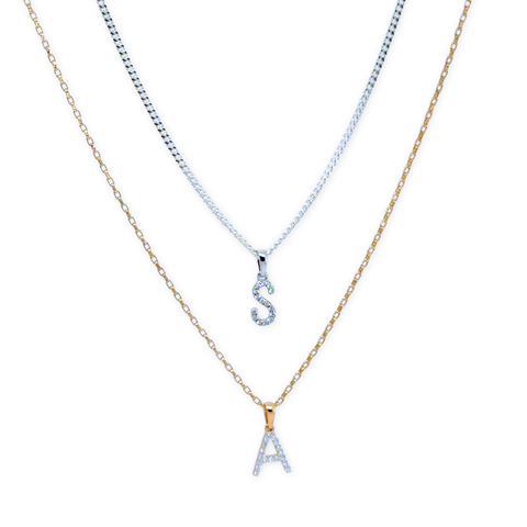 Diamond initial pendant necklace layered on chain