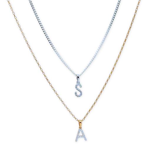 Diamond initial pendant necklace layered on chain