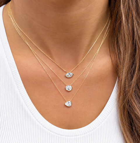 Marquise Aroha diamond necklaces layered with gold necklaces