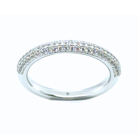 Refined diamond band in gold photographed in natural light, minimalist aesthetic