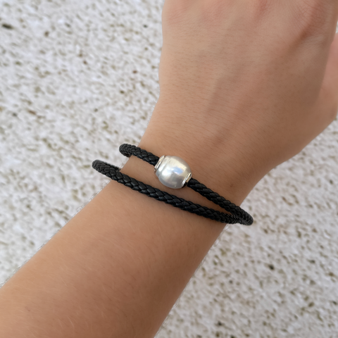 Double wrap black leather bracelet featuring white South Sea Autore pearl worn on wrist.