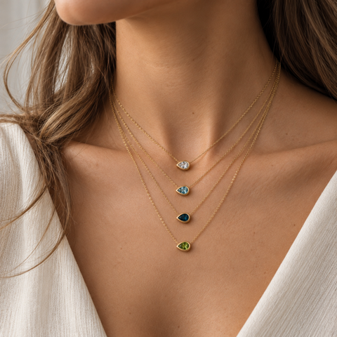 Pear Aroha gemstone necklace worn layered in 14kt yellow gold