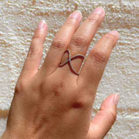 Yellow gold diamond infinity ring shown on hand in natural light