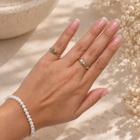 Zarah yellow gold oval signet ring worn on hand