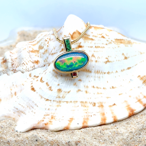 Australian semi-black opal pendant set in 18kt yellow gold