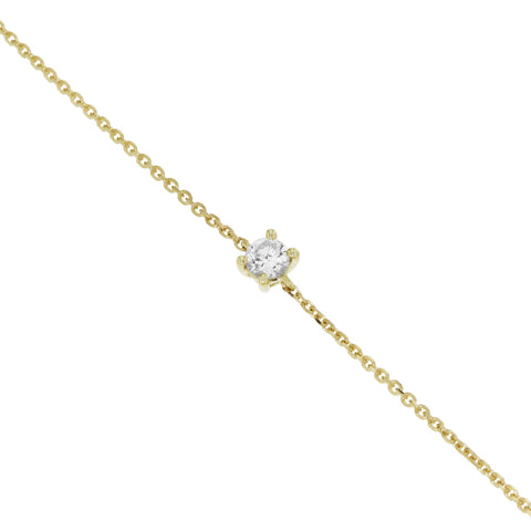 Gold birthstone bracelet with 3mm gemstone photographed laid out on white surface.